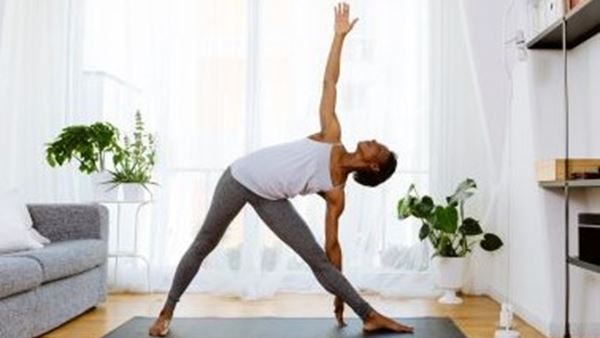 Woman doing triangle pose in yoga