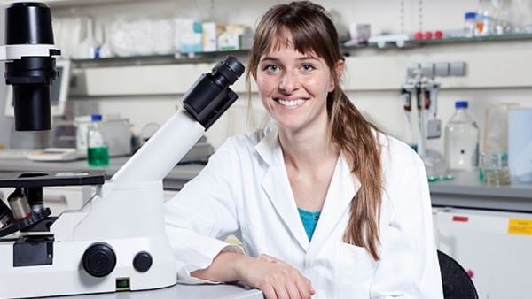 Woman in lab with microscope