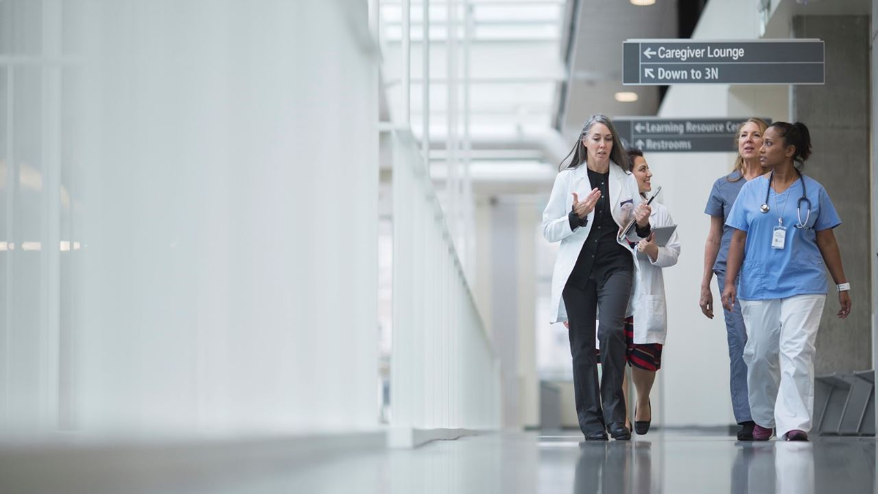 Clinicians walking in hospital corridor